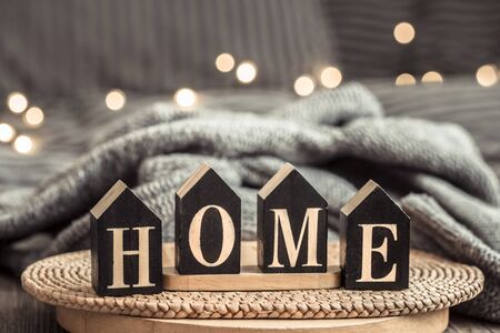 Cozy background with wooden letters with the inscription home . The concept of home atmosphere and comfort.の写真素材