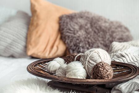 Still life with a cozy variety of yarn for knitting in the interior of the living room. The concept of hobby and comfort .の写真素材