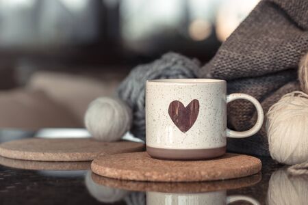Cozy Autumn still life background with a beautiful Cup with a heart . Close up.の写真素材