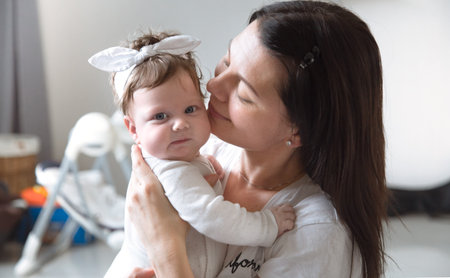 portrait of mom with cute little newborn girl. The concept of motherhood and family.