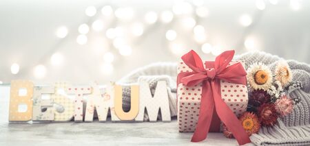 Mother's day holiday background, with multicolored flowers and wooden lettering.The concept of women's day Mothers .の写真素材