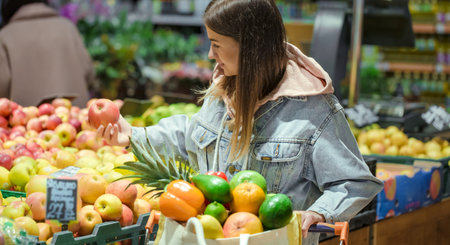 A young woman buys groceries in a supermarket. Health food. Healthy food, organic food.の写真素材