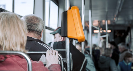 People sitting in public transport, close-up . Payment for public transport.