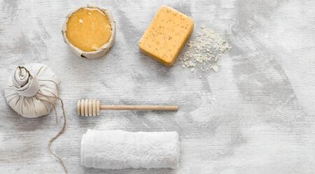Natural beautiful Spa cosmetics for body care, on a light wooden background. Honey and soap with items to cleanse the skin. The concept of health and body care .の写真素材