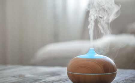 Humidifier on the table in the living room. Ultrasonic technology, increase the humidity in the room, comfortable living conditions.の写真素材