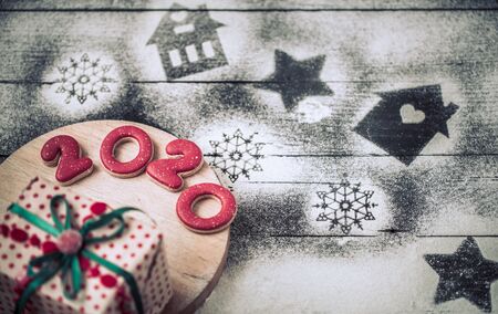 Festive beautiful gingerbread on a stick, cooking concept. The view from the top. On a black wooden background .の写真素材