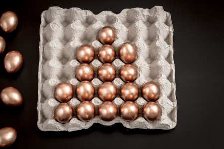 Golden Easter eggs on black background. The concept of the Easter holiday.の写真素材