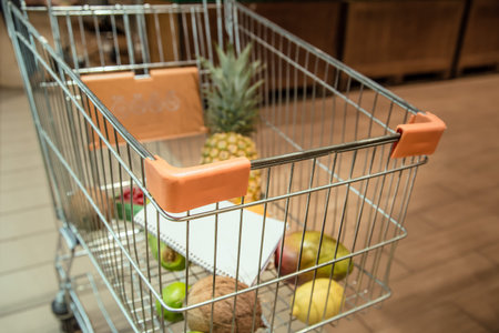 Trolley with food fruits and Notepad in the supermarket . Health food. Healthy food, organic food.の写真素材
