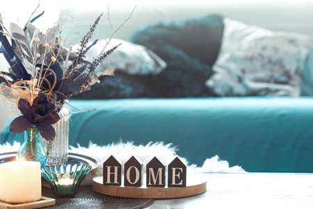 Still life in blue tones, with wooden inscription home and decorative elements, in the living room .
