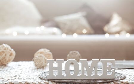 Still life in the living room with a wooden inscription home . The concept of home and comfort.の写真素材