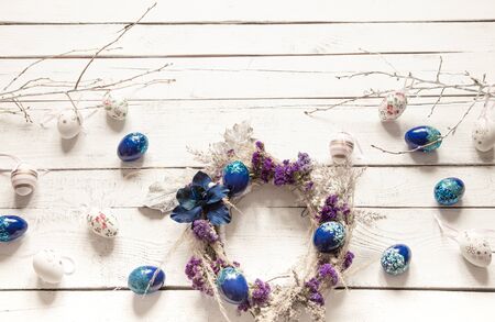 Stylish composition with an Easter wreath and eggs trend blue. The concept of Easter decorations and celebration.の写真素材