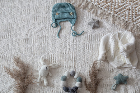 Set of children's stylish handmade knitted clothes with various accessories in the boho style, top...