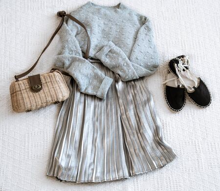 Set with fashionable women's clothing skirt and sweater, sandals and accessories . Top view, flat lay.の写真素材