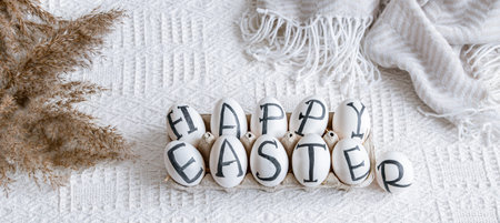 Easter eggs with the inscription happy Easter, holiday decor . Still life with an Easter cozy mood.