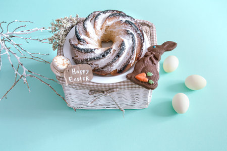Easter composition with eggs and cupcake on a colored background. The concept of the Easter...