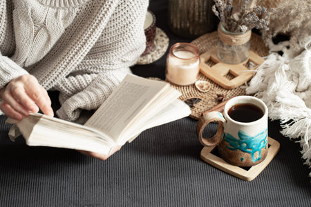 Still life with a beautiful Cup and female hands. An intimate, homely atmosphere. decorative items.