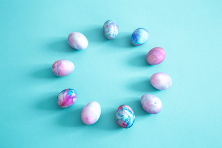 Circle of Easter eggs on a colored isolated background. The concept of the Easter holidays.