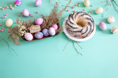 Easter composition with eggs and cupcake on a colored background. The concept of the Easter...