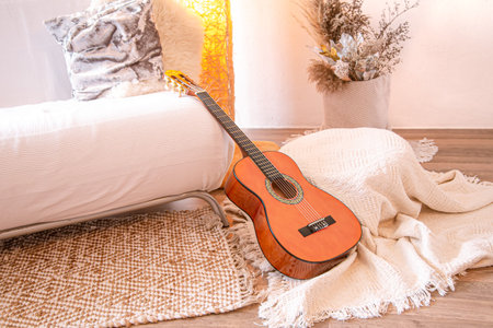 Modern cozy stylish interior of the living room with a guitar .