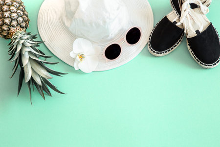 Colorful summer female fashion outfit flat-lay.White stylish women's hat with sunglasses and fresh...