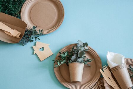 Eco-friendly, stylish recyclable paper tableware. Paper food boxes, plates, and cornstarch Cutlery on a trending mint and blue background .の写真素材