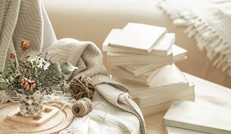 Home cozy interior of the room with books and dried flowers in a vase. The concept of home entertainment.の写真素材