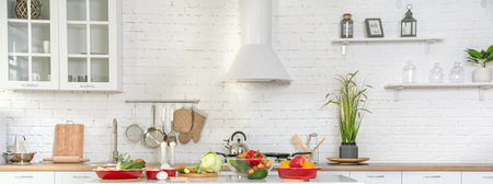 Modern stylish kitchen interior with vegetables and fruits on the table . Bright white kitchen with...