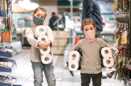 Children shopping at the supermarket during the pandemic . COVID-19 outbreak. Epidemic of virus covid.の写真素材