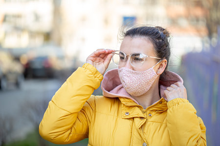Close-up portrait young woman in a mask during the pandemic. coronavirus COVID-19 . Concept of...