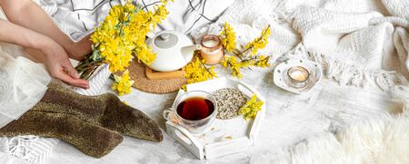 Spring still life with a Cup of tea and flowers .の写真素材