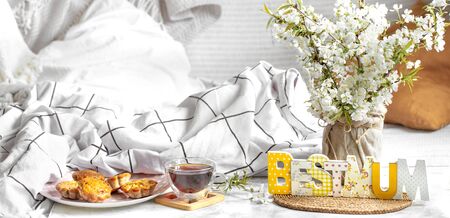 Mother's day holiday, cozy background composition with flowers . Cozy atmosphere in the bedroom, home and family.の写真素材