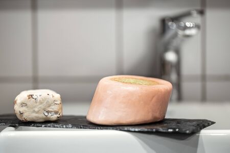 Bathroom with two bars of fine soap near the washbasin. Hygiene and careの写真素材