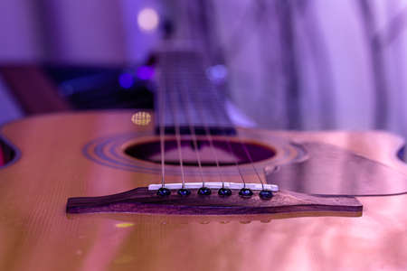 Acoustic guitar on a beautiful colored background. The concept of stringed instruments. Close up.の写真素材