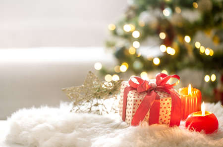 New year holiday background with a gift box in a cozy home atmosphere . The concept of the celebration.の写真素材