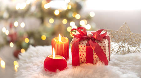 New year holiday background with a gift box in a cozy home atmosphere. The concept of the celebration.の写真素材