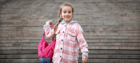 Back to school girl with a briefcase. The beginning of lessons and the first day of autumn. A sweet...