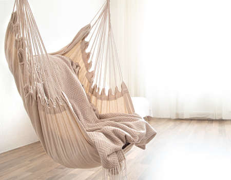 Hammock chair in boho style. Cozy interior. The concept of rest and home comfort. Space for text.の写真素材