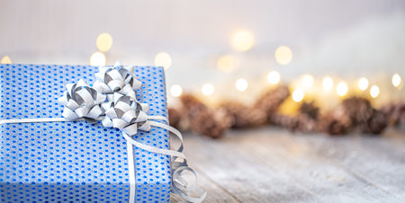 New year holiday background with a blue gift box. The concept of greeting and celebrating the New...