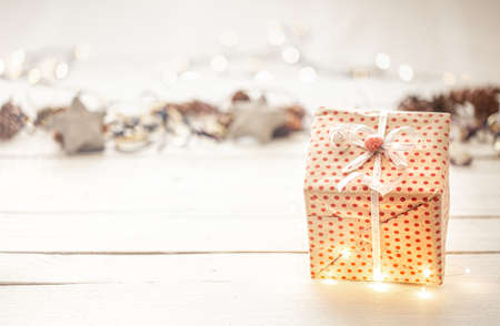 Festive new year background with a gift box and lights. Concept of holidays and gifts.の写真素材
