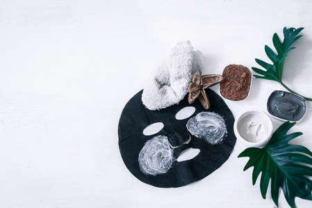 Spa composition with face care items with a black mask on a white background. Modern concept of Spa and beauty products.の写真素材