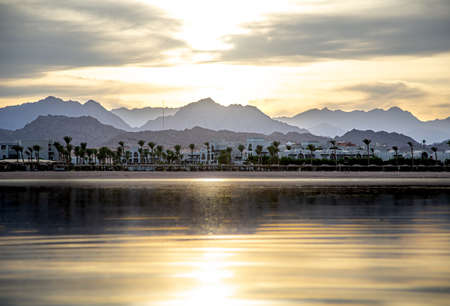 Beautiful background landscape at sunset by the sea. With lone figures in the distance.の写真素材