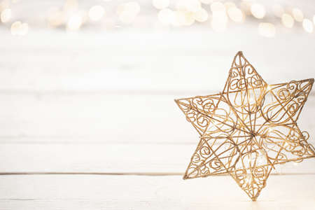 Festive new year background with a star and lights. Concept of holidays and gifts.の写真素材