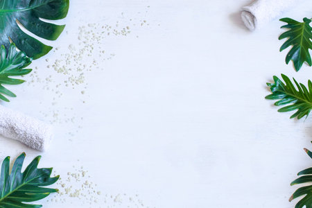 Spa composition with body care items and natural leaves on a white background. Concept of...