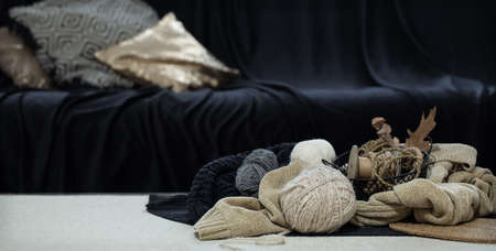 Still life of balls of thread close-up in dark blue tones on a blurred background of the living room copy spaceの写真素材