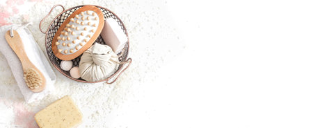 Spa composition with massage brush, soap, herbal compress ball on white background top view and copy...