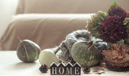 Autumn still life of pumpkins, autumn leaves, hydrangea flowers and wood decor in the foreground close up.の写真素材