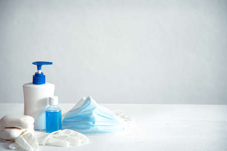 Antivirus set of items: various filtering safety face masks, sanitizer for hands, soap on light background. Stop virus concept.の写真素材