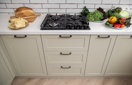 White kitchen furniture in white in the style of minimalism with products for cooking top view.