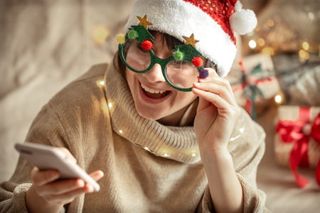 A funny girl communicates by video communication via the phone. The concept of communication at a...