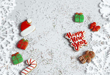 Winter background with decorated with glaze gingerbread, snowflakes and confetti top view. Happy new year and christmas banner concept.の写真素材